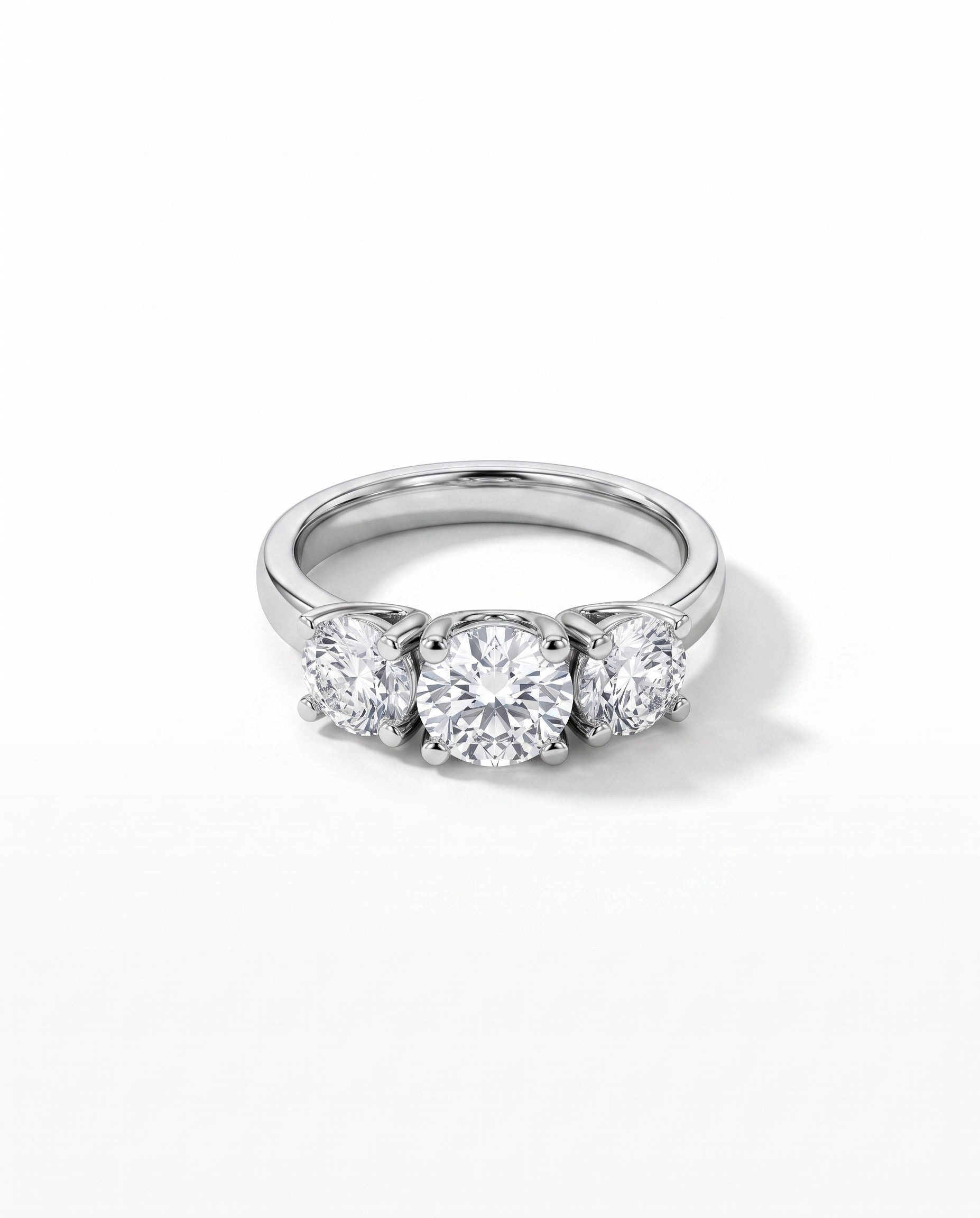 Platinum trilogy ring with three round diamonds in a four claw V set.