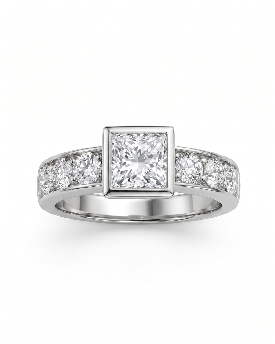 White gold engagement ring with a princess cut diamond and channel-set round diamonds.