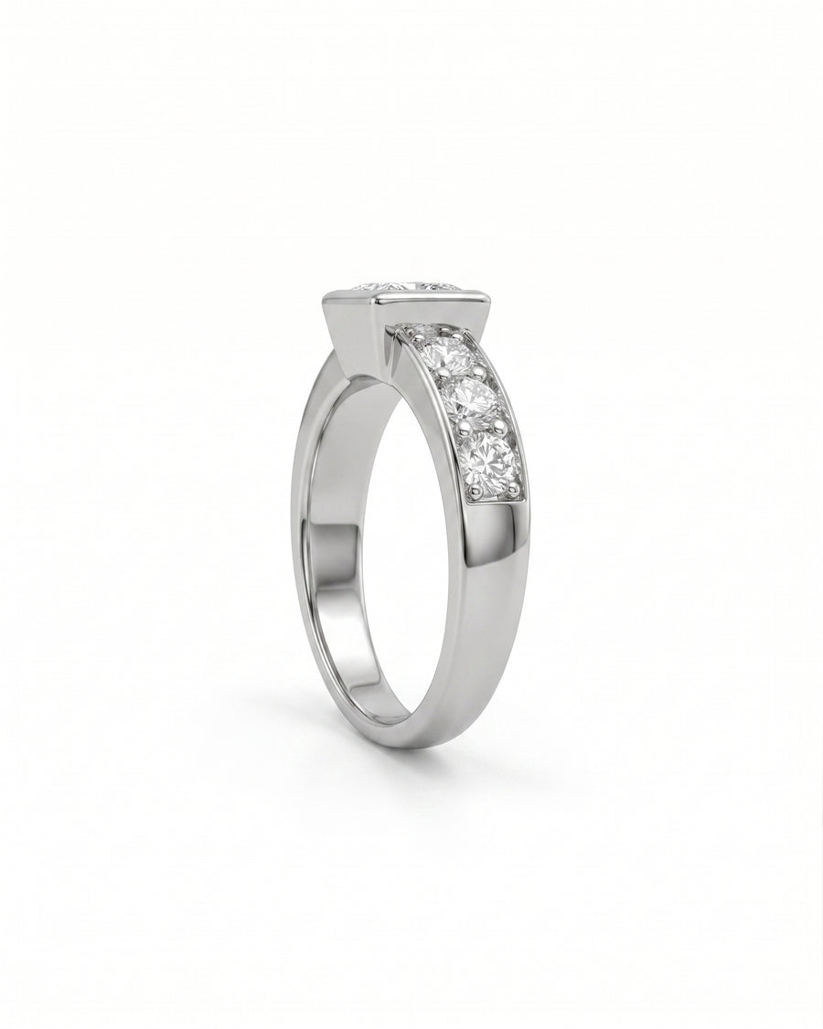 White gold engagement ring with a princess cut diamond and three round side diamonds.
