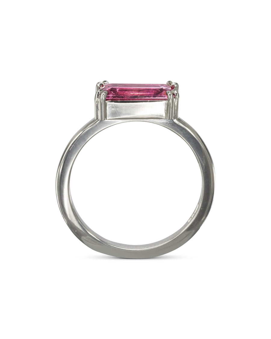 Silver ring with a pink baguette gemstone.