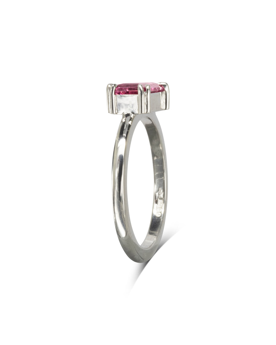 Silver ring with a pink baguette gemstone.