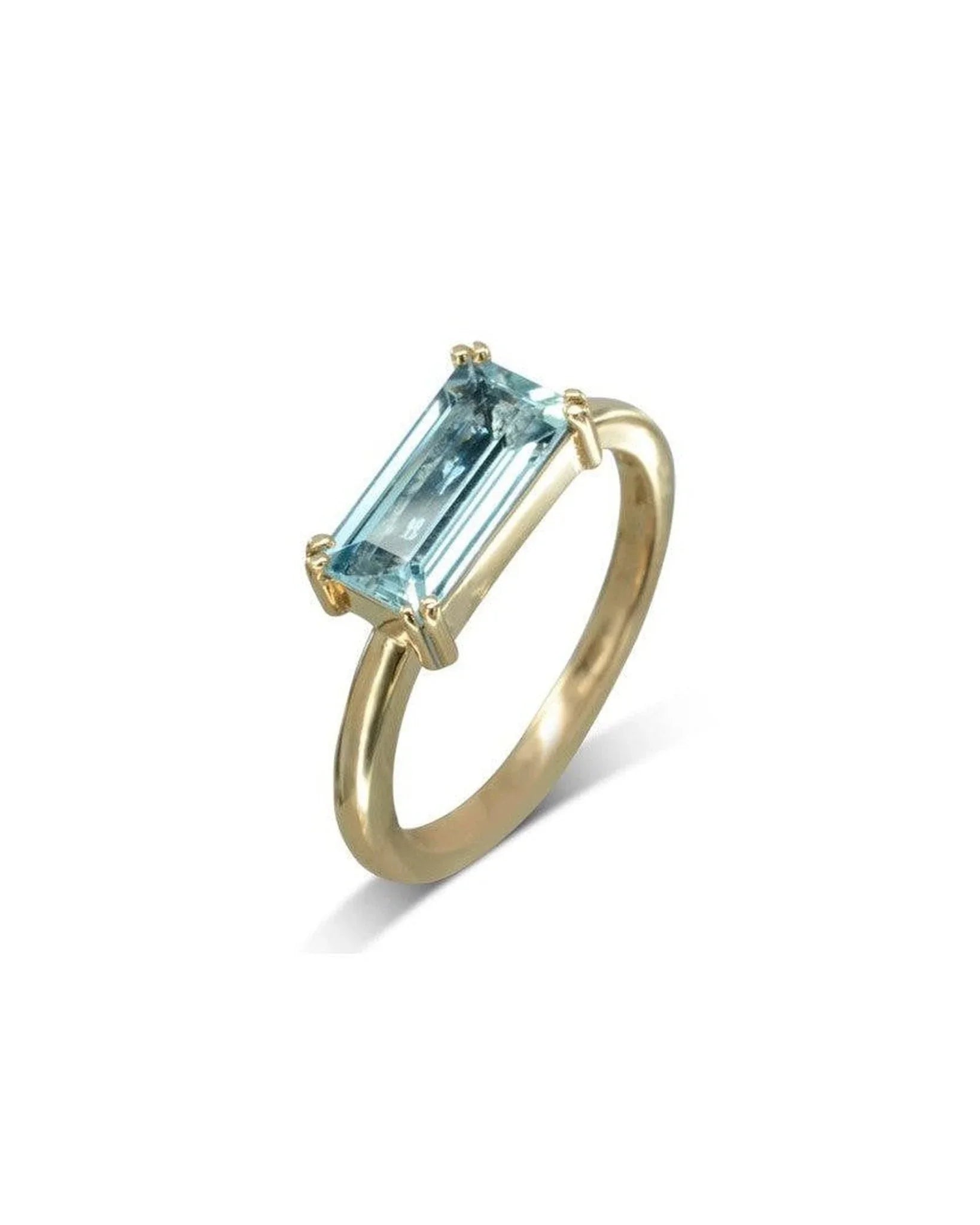 Gold ring with a baguette-cut aquamarine gemstone set in a minimalist claw setting