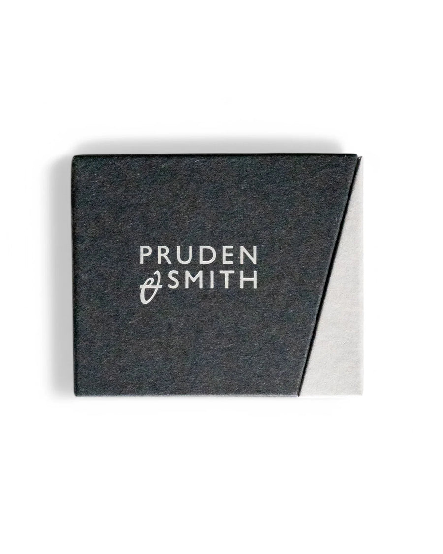 Black and white paper jewelry box with "PRUDEN SMITH" logo.