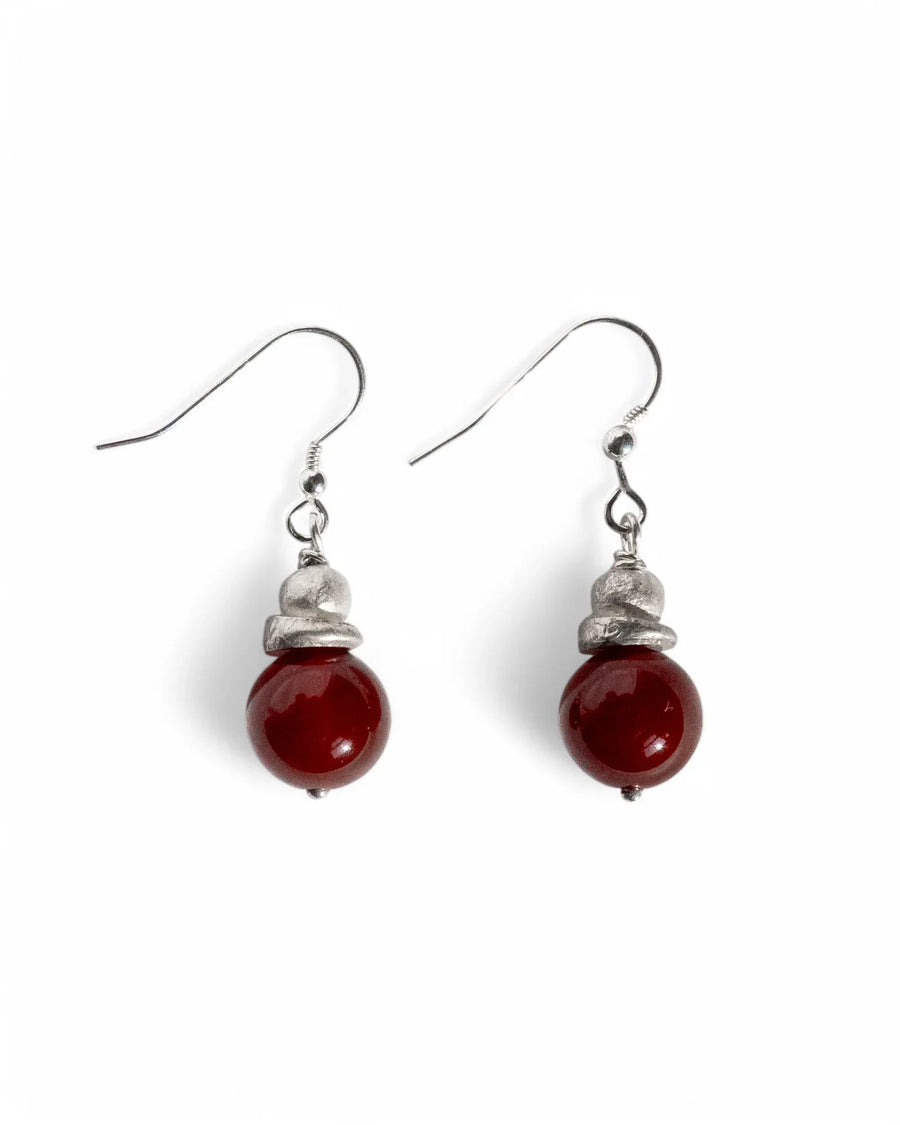 Silver hook earrings with reddish-orange carnelian gemstone bead drops.