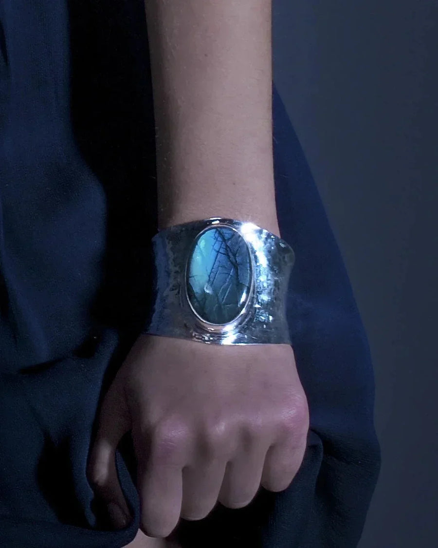 Solid silver cuff bangle with a large oval labradorite gemstone.
