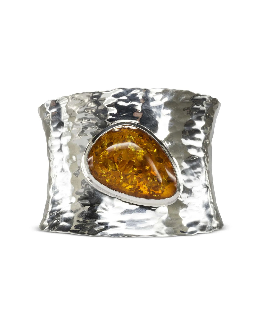 Hammered solid silver cuff bangle with a large amber gemstone.
