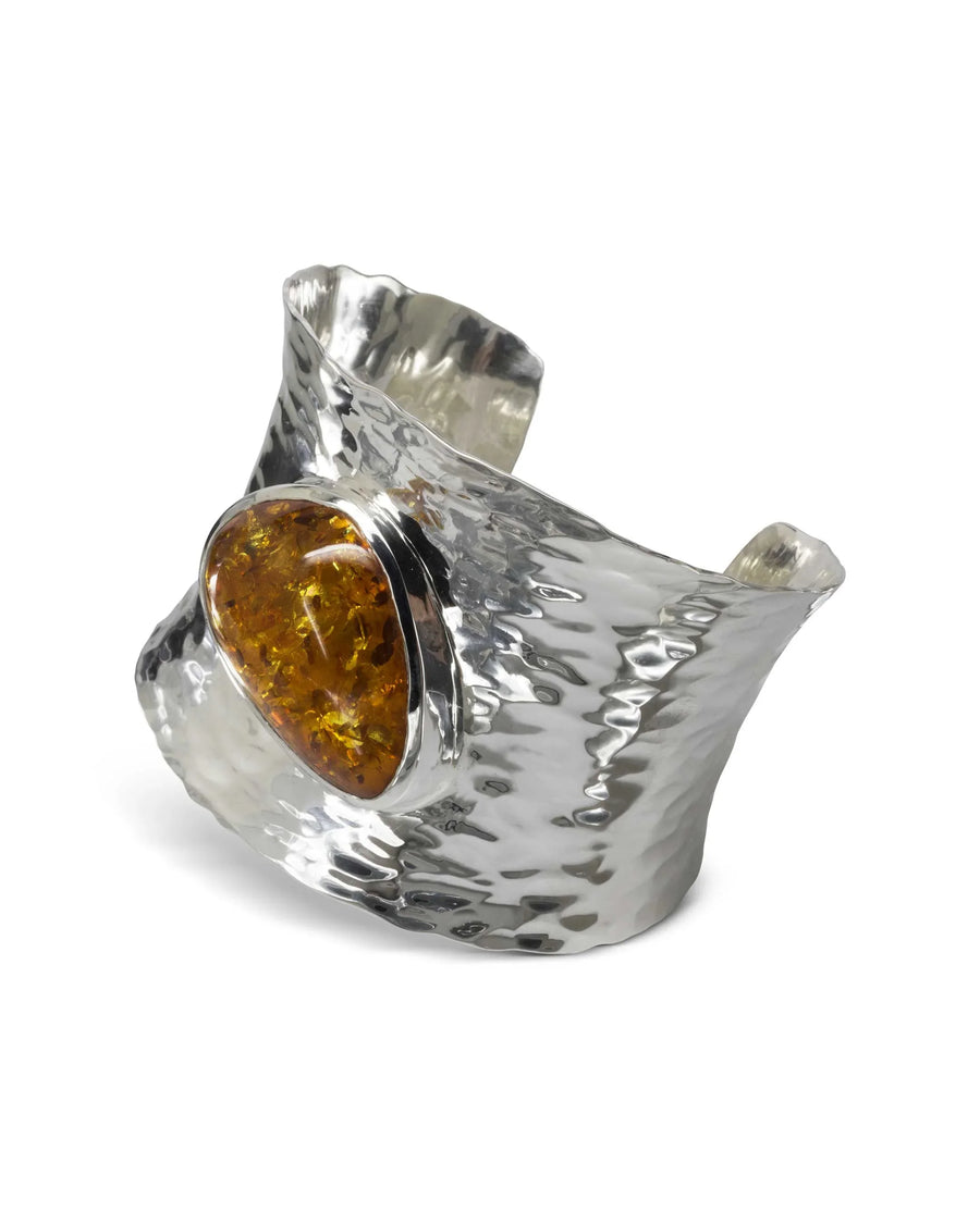 Hammered solid silver cuff bangle with an oval amber gemstone.