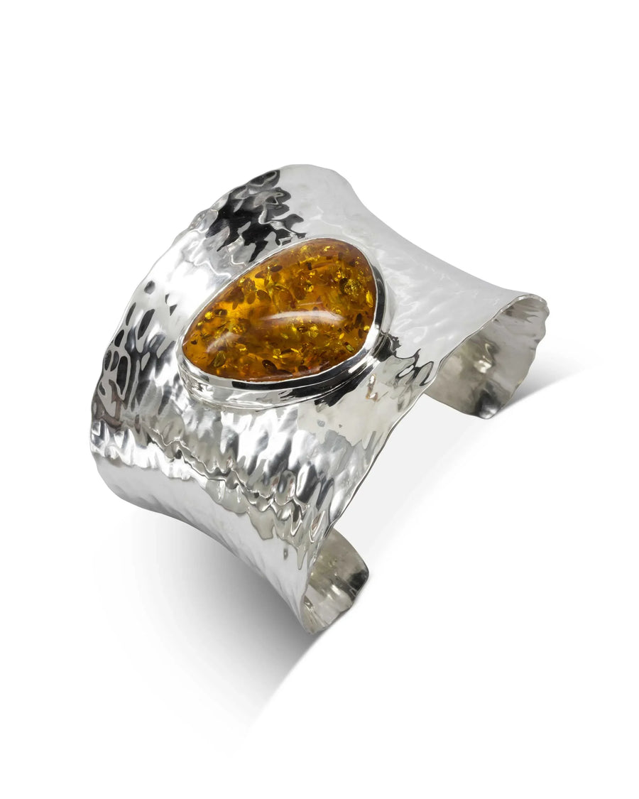 Hammered solid silver cuff bangle with an oval amber gemstone.