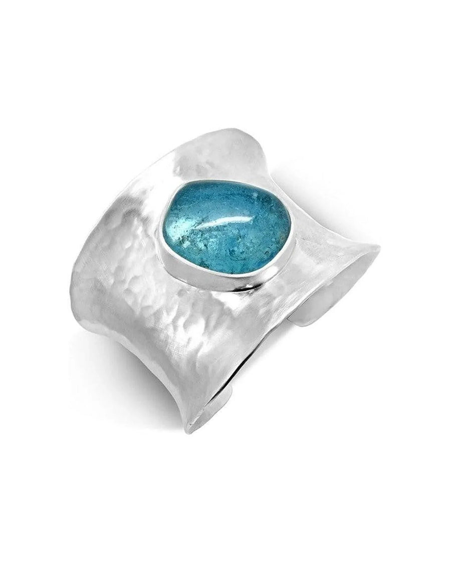 Hammered silver cuff bangle with an oval aquamarine gemstone.