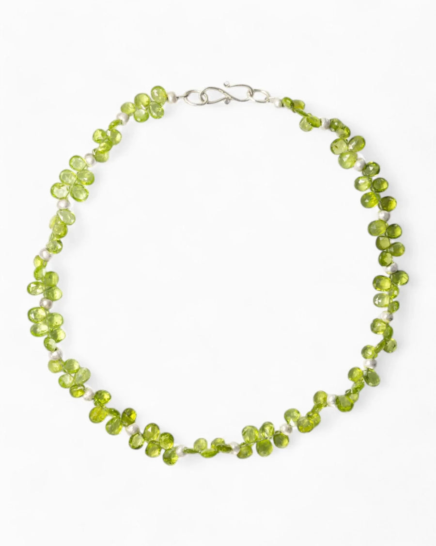 Handmade teardrop green gemstone necklace with organic clustered design on white background