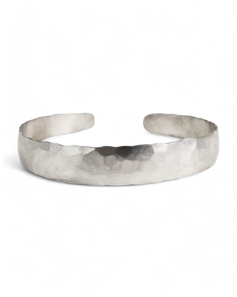 Hammered edge matte solid gold bangle with organic, textured finish on white background