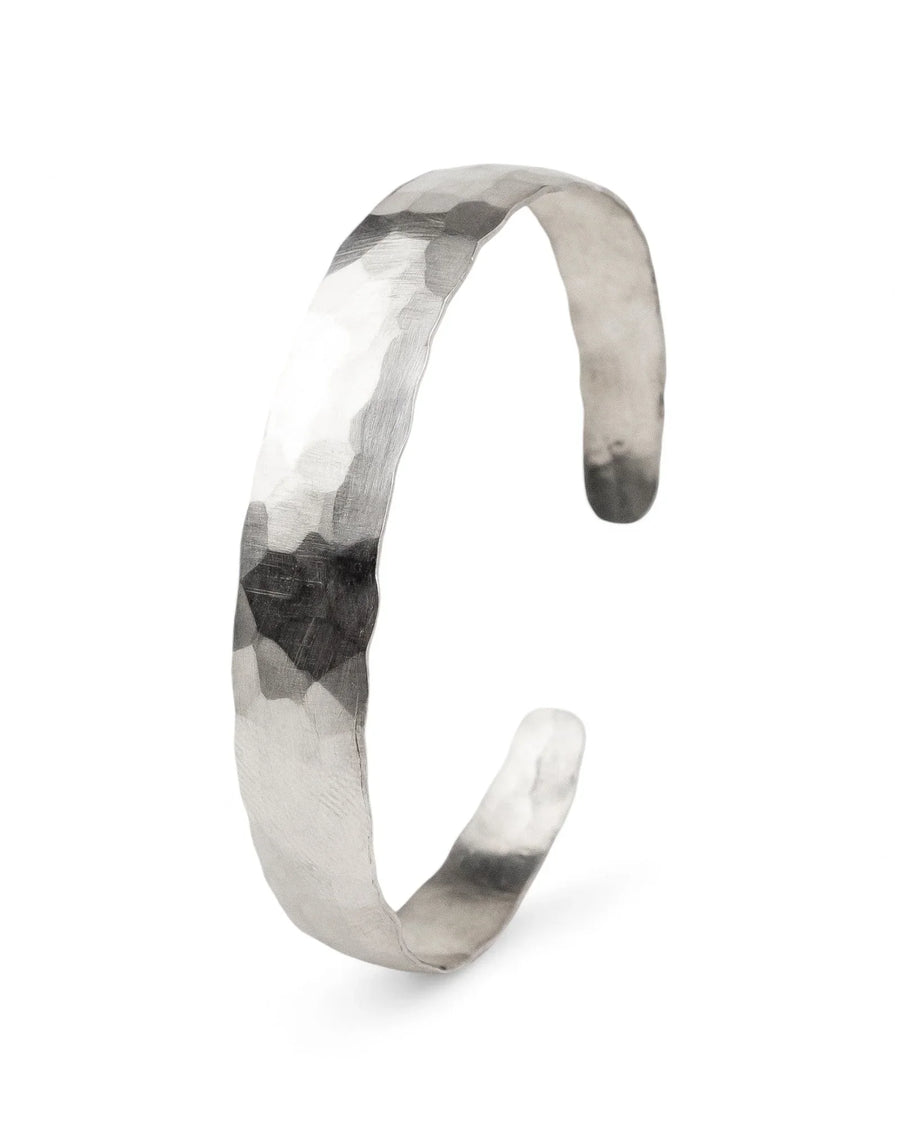 Matte solid gold bangle with hammered edge texture on a white background