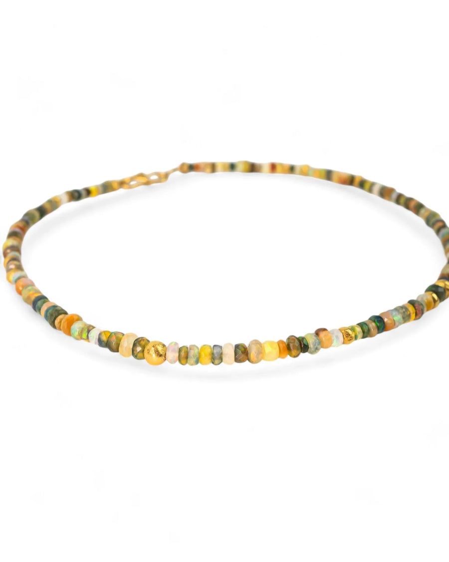 Delicate beaded gold nugget and opal necklace with earthy tones on a white background