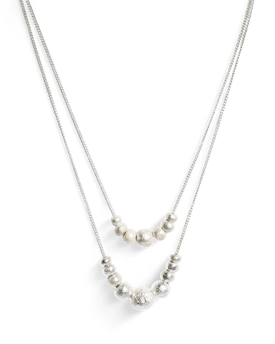 Layered silver necklaces with organic textured beads on box chains, minimalist jewellery