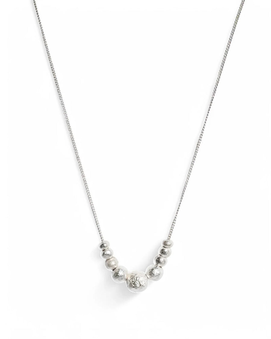 Sterling silver pendant necklace with textured round beads on a delicate chain, handmade jewelry