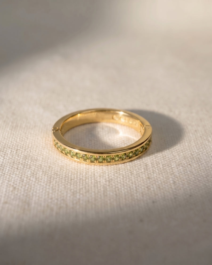 9ct yellow gold hinged eternity ring with green diamonds.