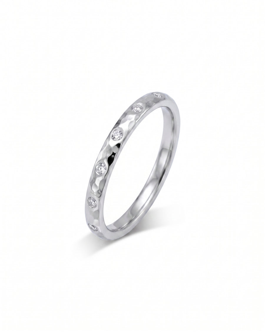 Silver hammered diamond ring with round brilliant cut diamonds.