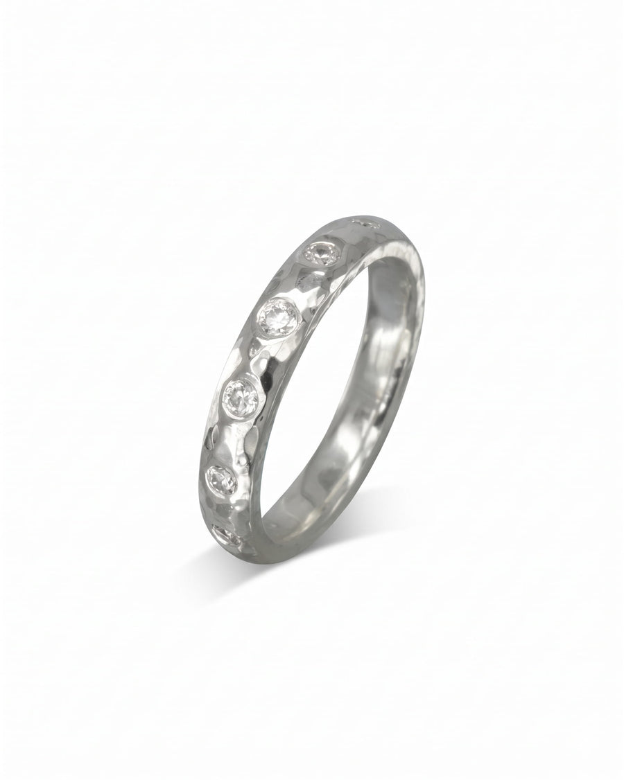 Silver hammered diamond ring with five round diamonds.