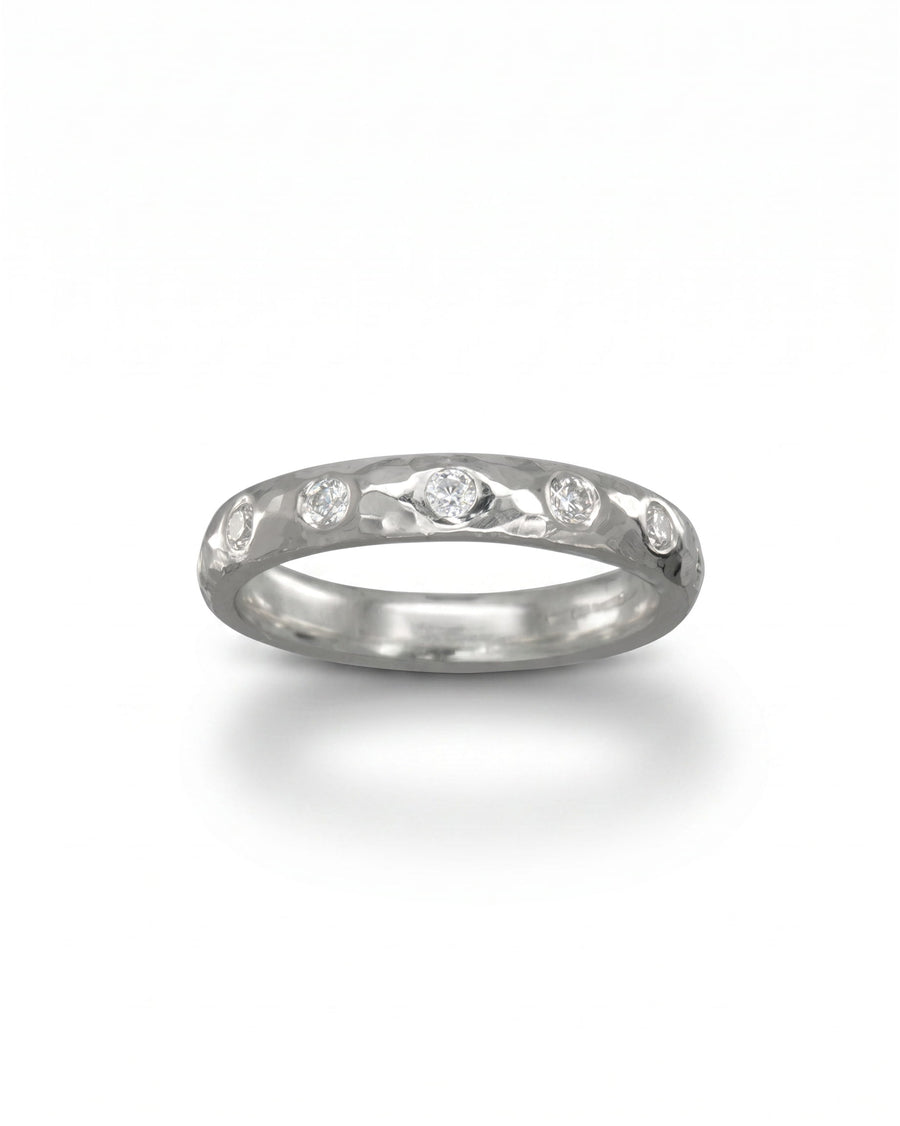 Silver hammered diamond ring with five round diamonds.