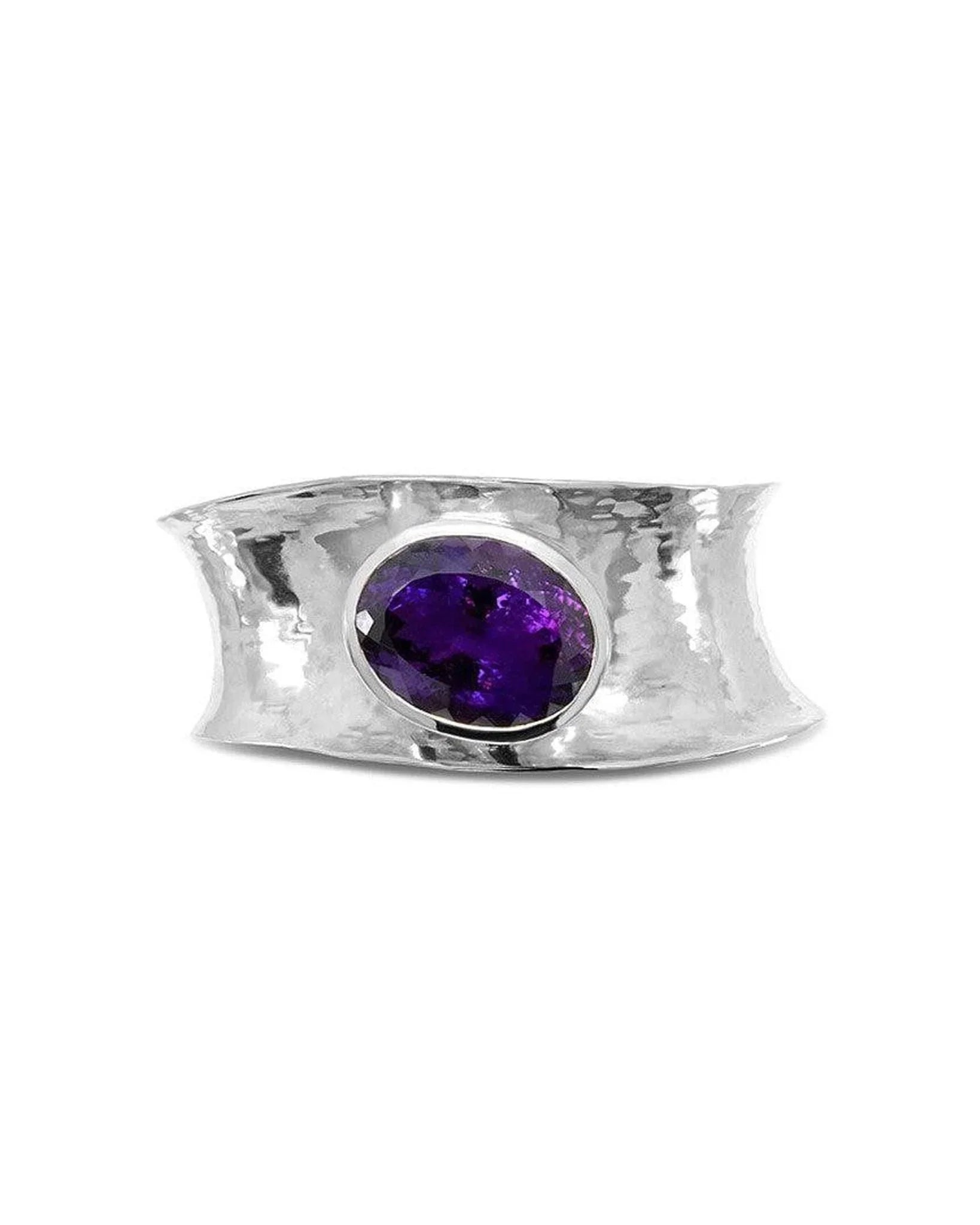 Hammered silver cuff bangle with an oval amethyst gemstone.