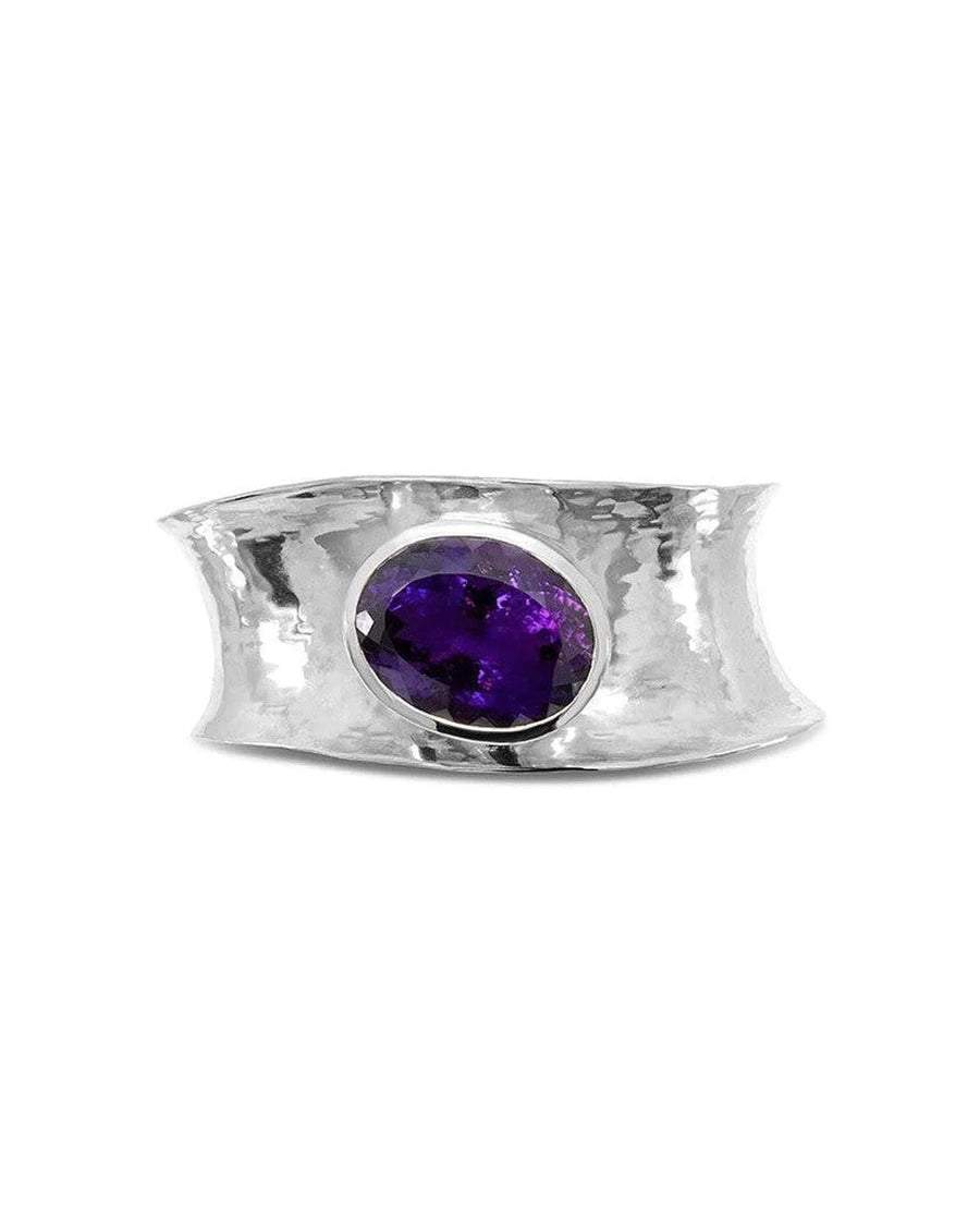 Hammered silver cuff bangle with an oval amethyst gemstone.