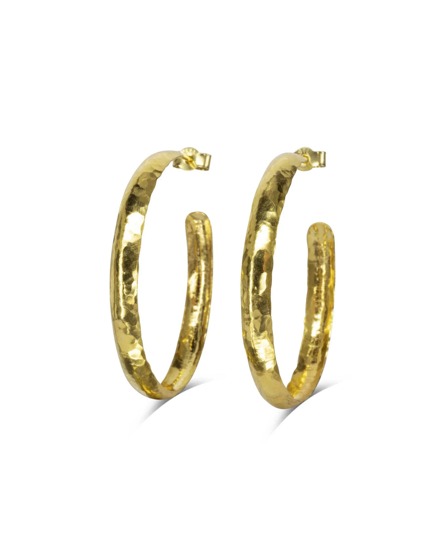 Handmade gold planished narrow hoop earrings with hammered texture on white background