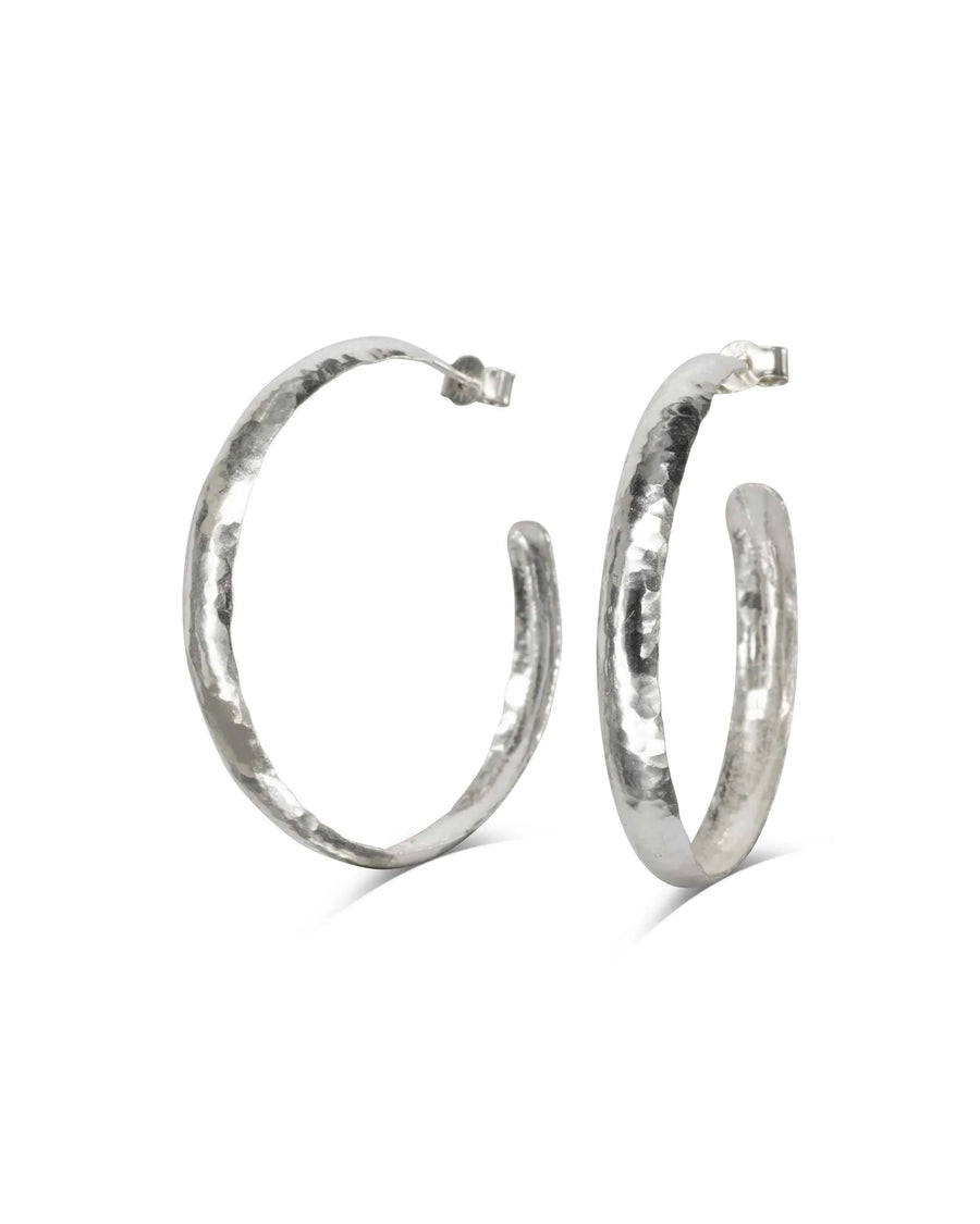 Handmade silver planished narrow hoop earrings with hammered texture on white background