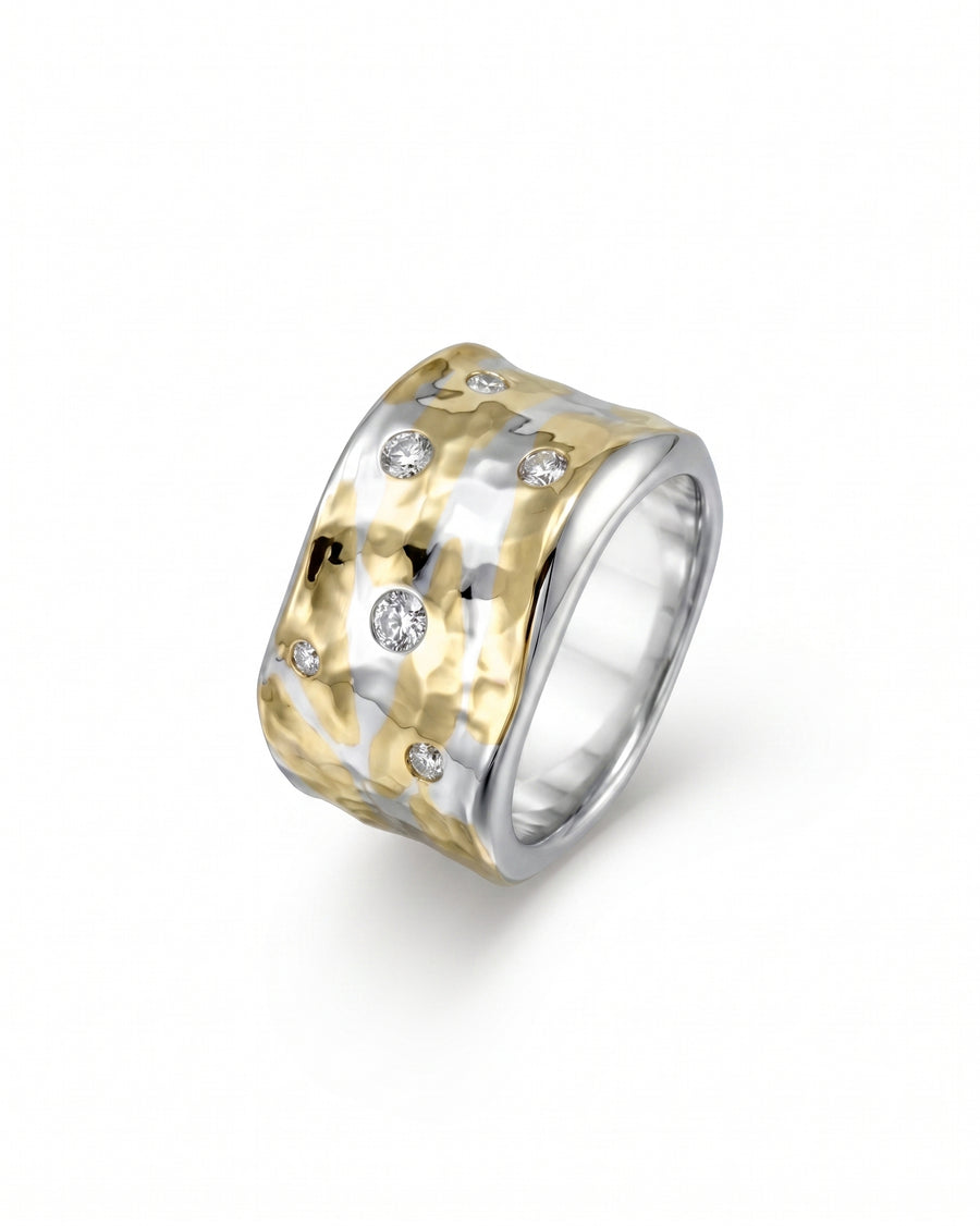 Wide hammered mixed metal ring with scattered diamonds.