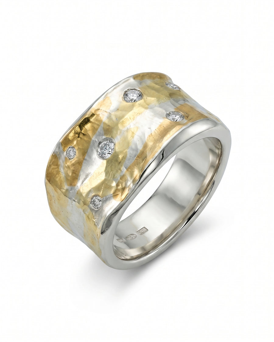 Wide hammered mixed metal ring with scattered diamonds.