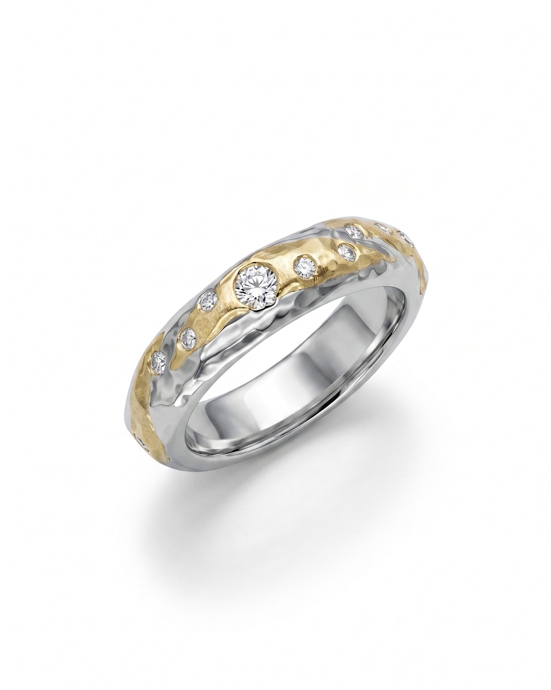 Hammered mixed metal gold and silver ring with scattered diamonds.