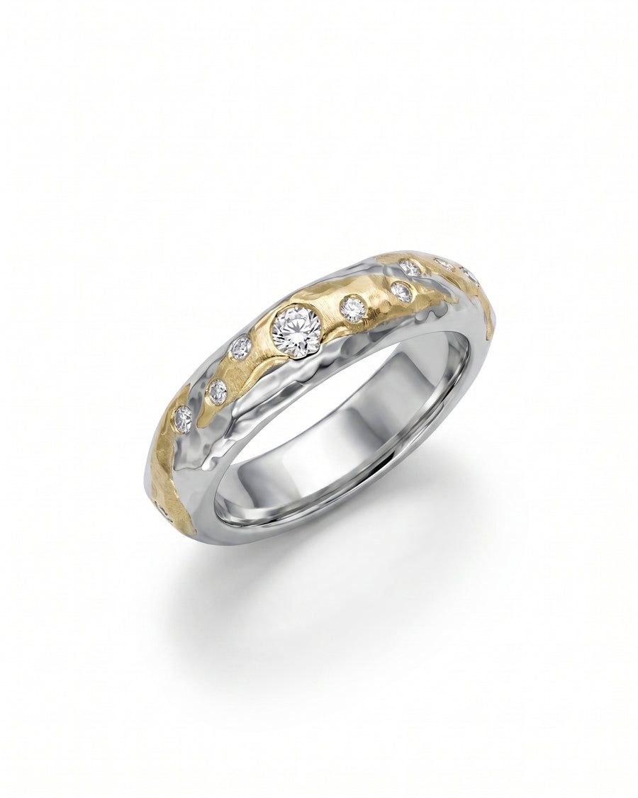 Hammered mixed metal gold and silver ring with scattered diamonds.