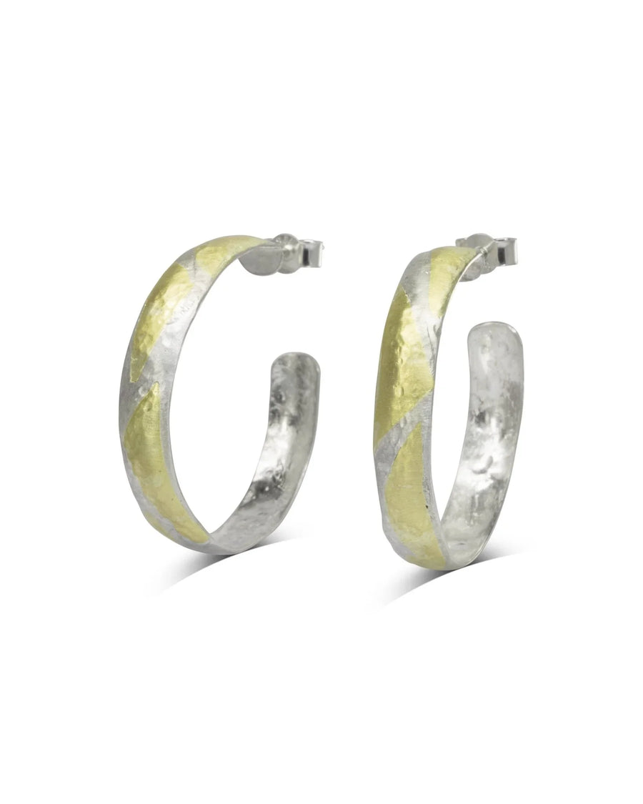 Hammered silver and 9ct yellow gold hoop earrings with a rough texture.