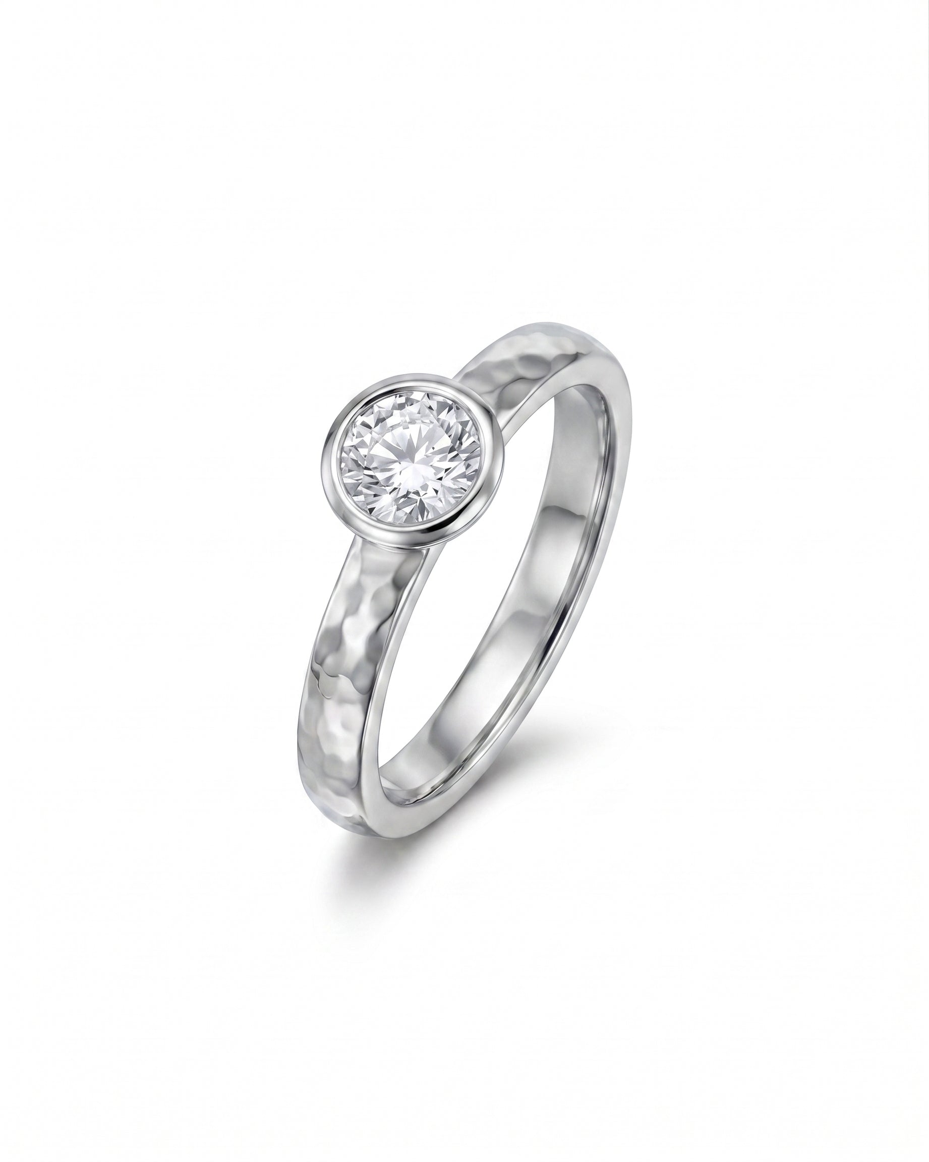 Hammered platinum ring with a round brilliant cut diamond.
