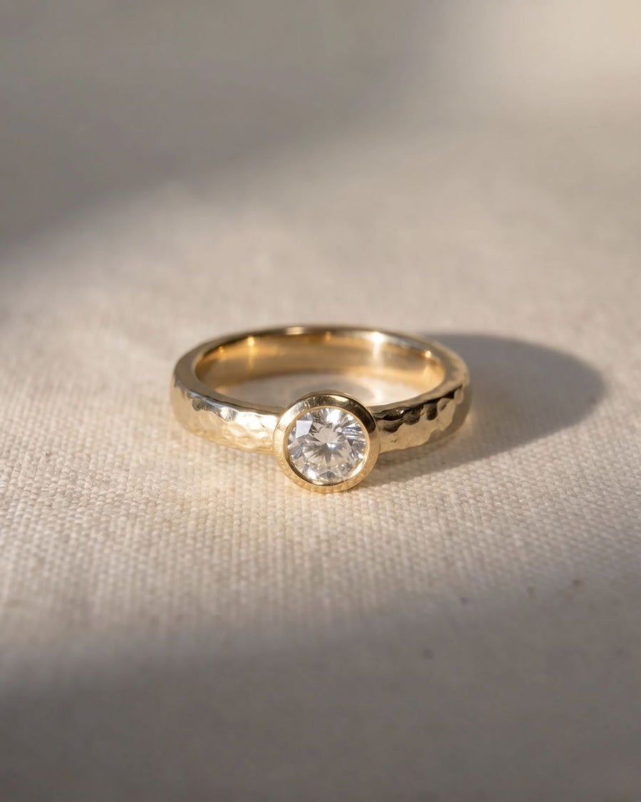 Hammered 9ct yellow gold ring with a round brilliant cut natural diamond.