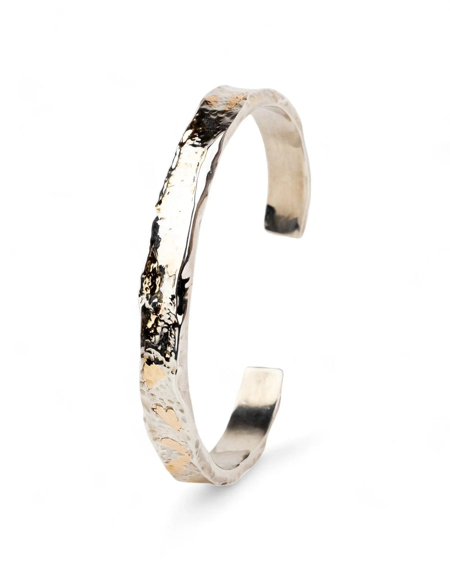 Hammered silver and gold cuff bangle with an organic, textured design.