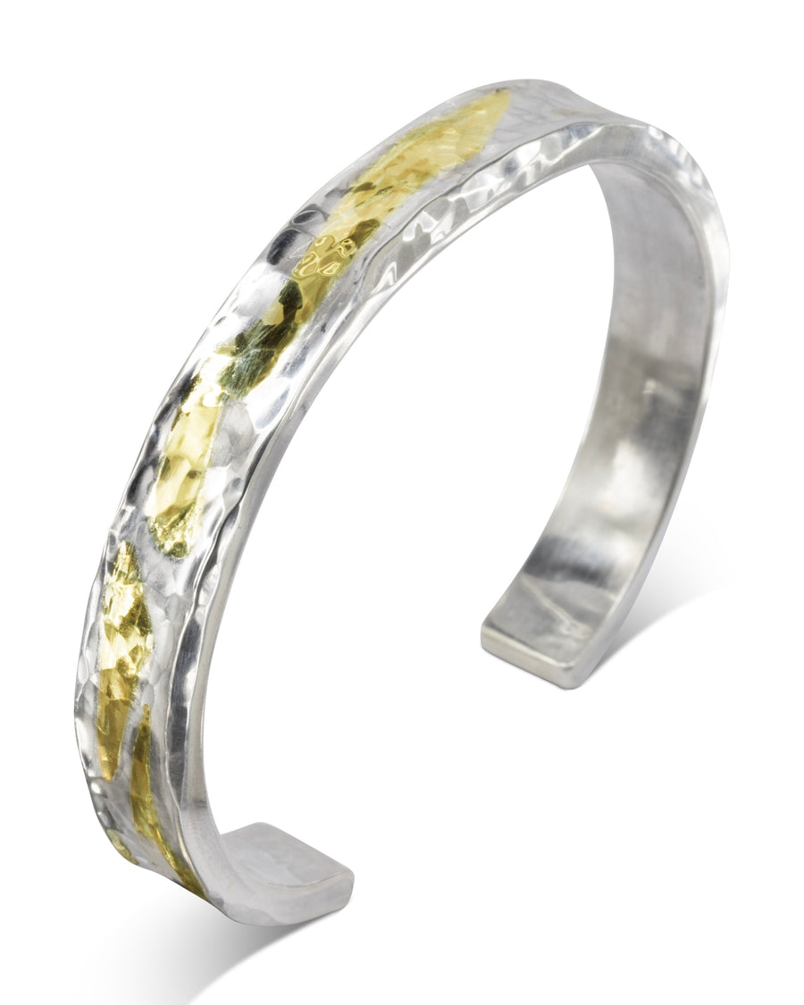 Hammered silver and 9ct yellow gold cuff bangle.