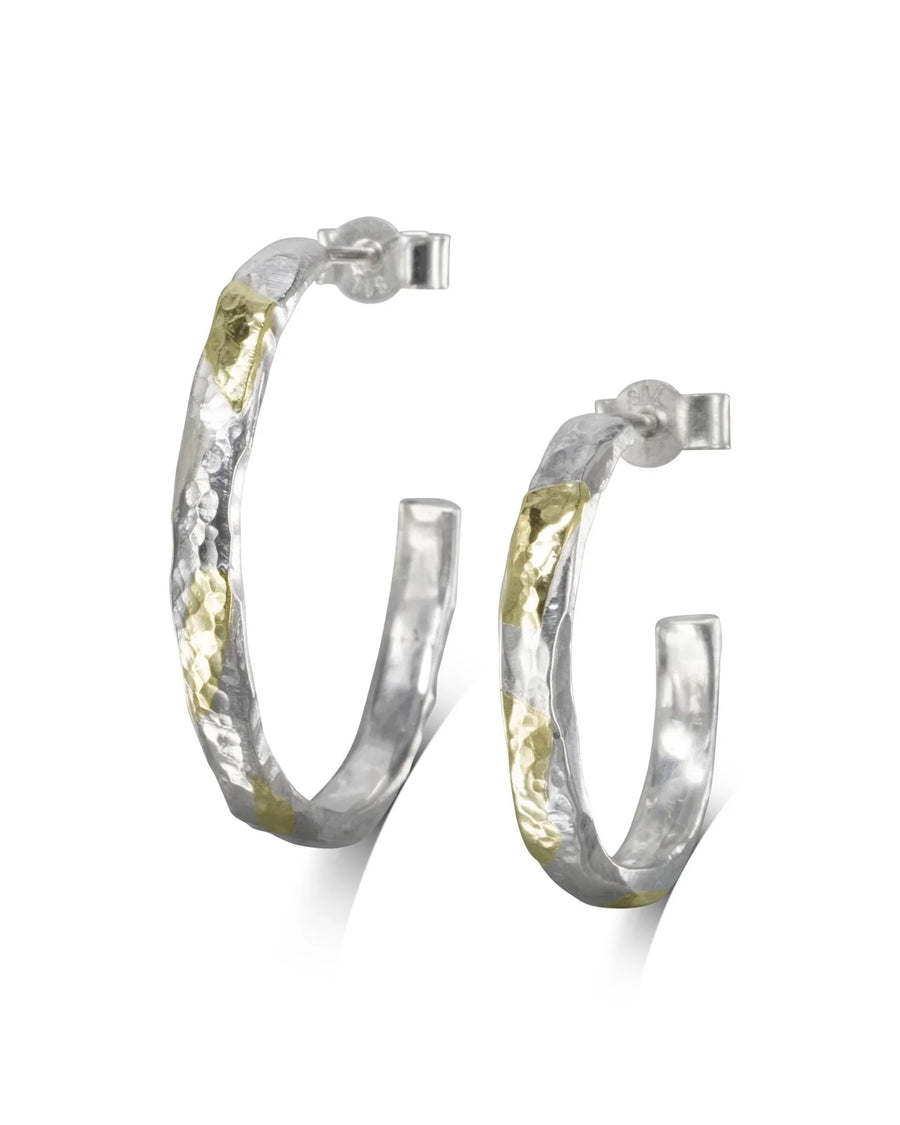 Hammered silver and gold hoop earrings.