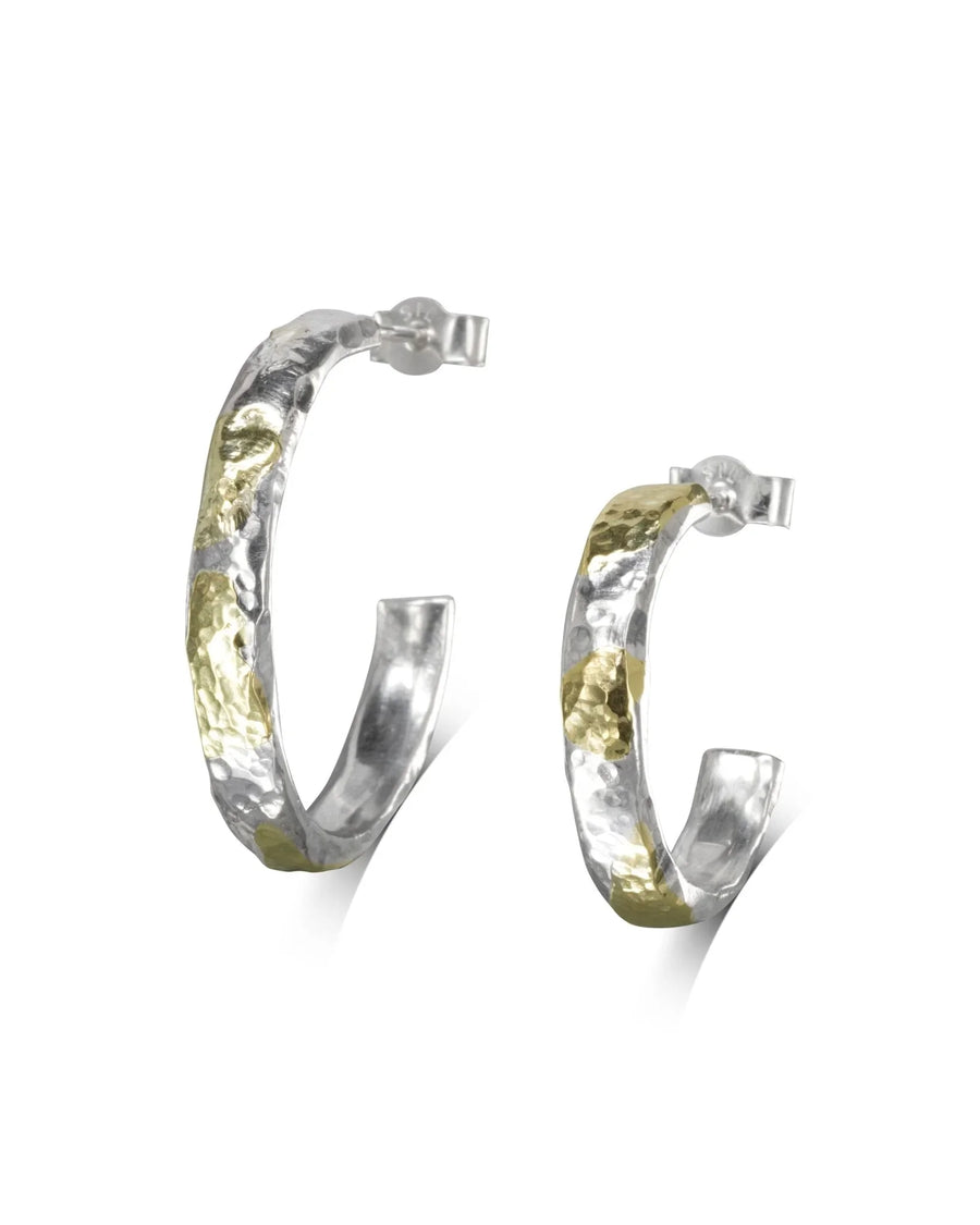 Hammered silver and gold hoop earrings.