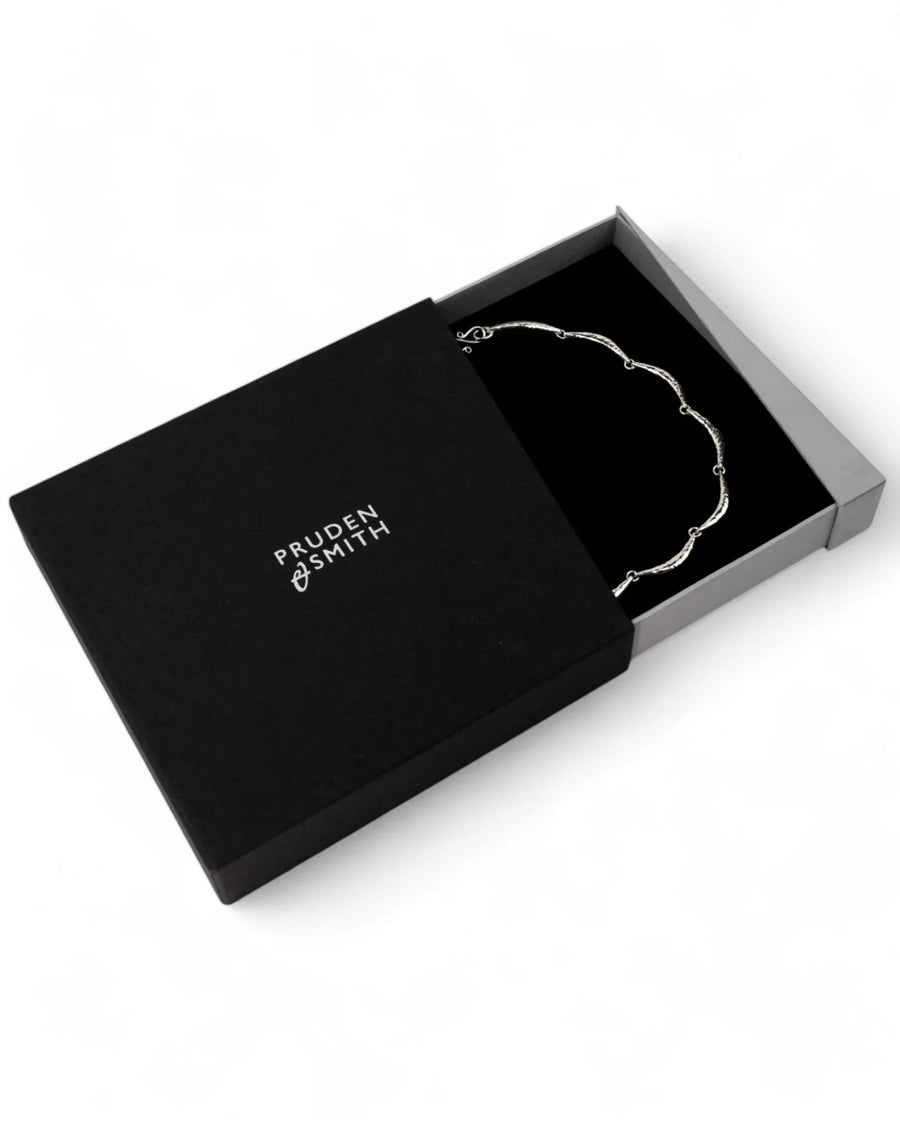 Handmade hammered silver crescent necklace with organic design in a gift box