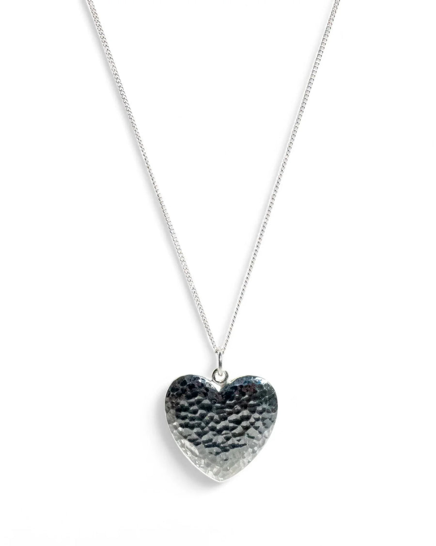 Hammered silver heart pendant necklace with an organic texture on a simple chain
