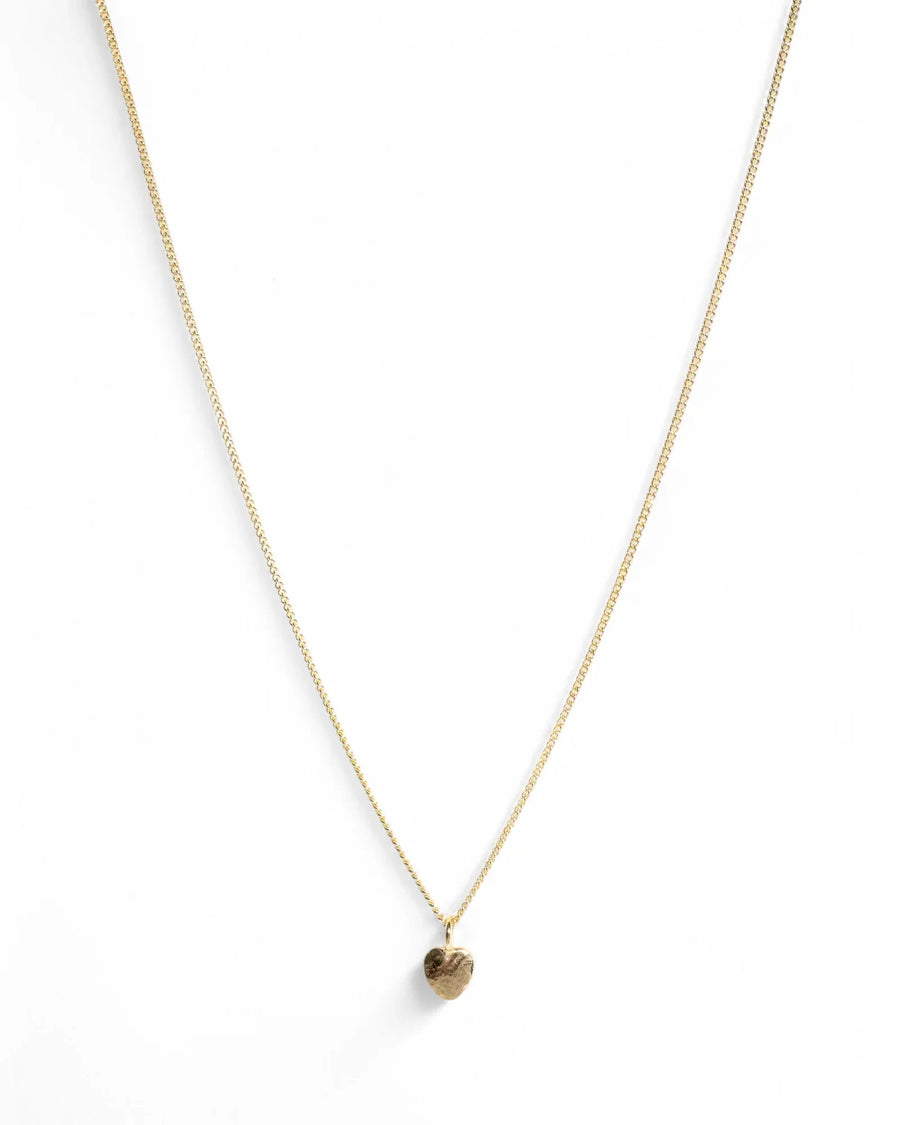 Gold chain necklace with hammered heart pendant on white background
