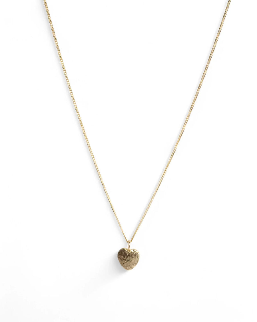 Gold heart pendant necklace with hammered texture on a delicate chain, minimalist jewellery