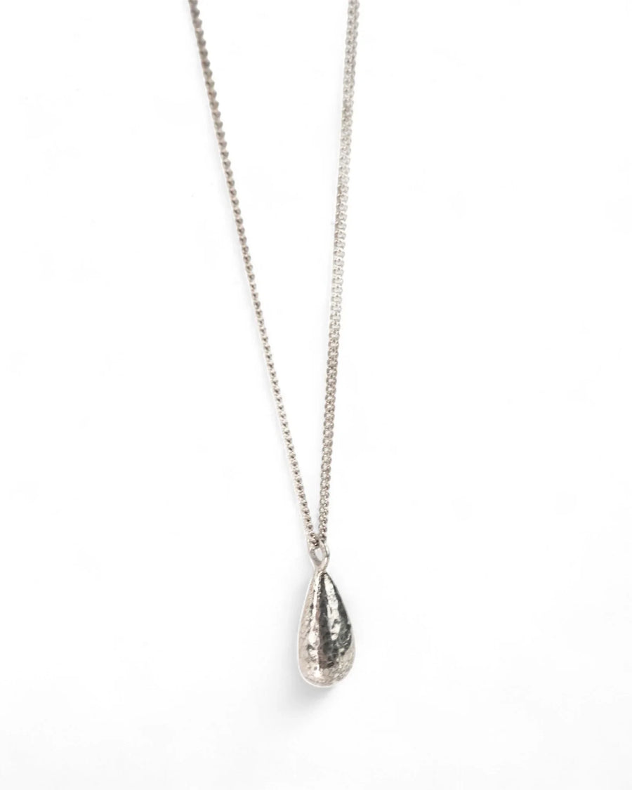 Hammered silver teardrop pendant necklace with textured finish on a fine chain