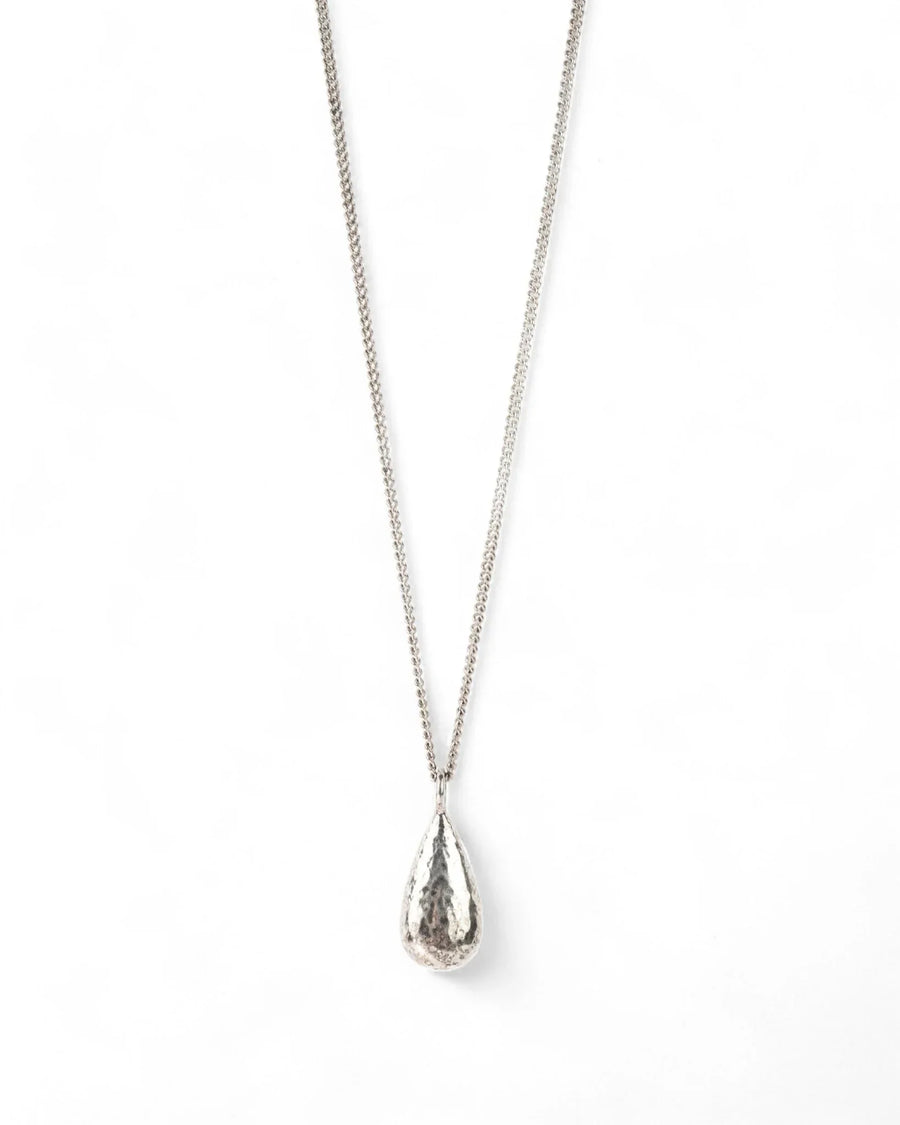 hammered silver teardrop pendant necklace on a plain background