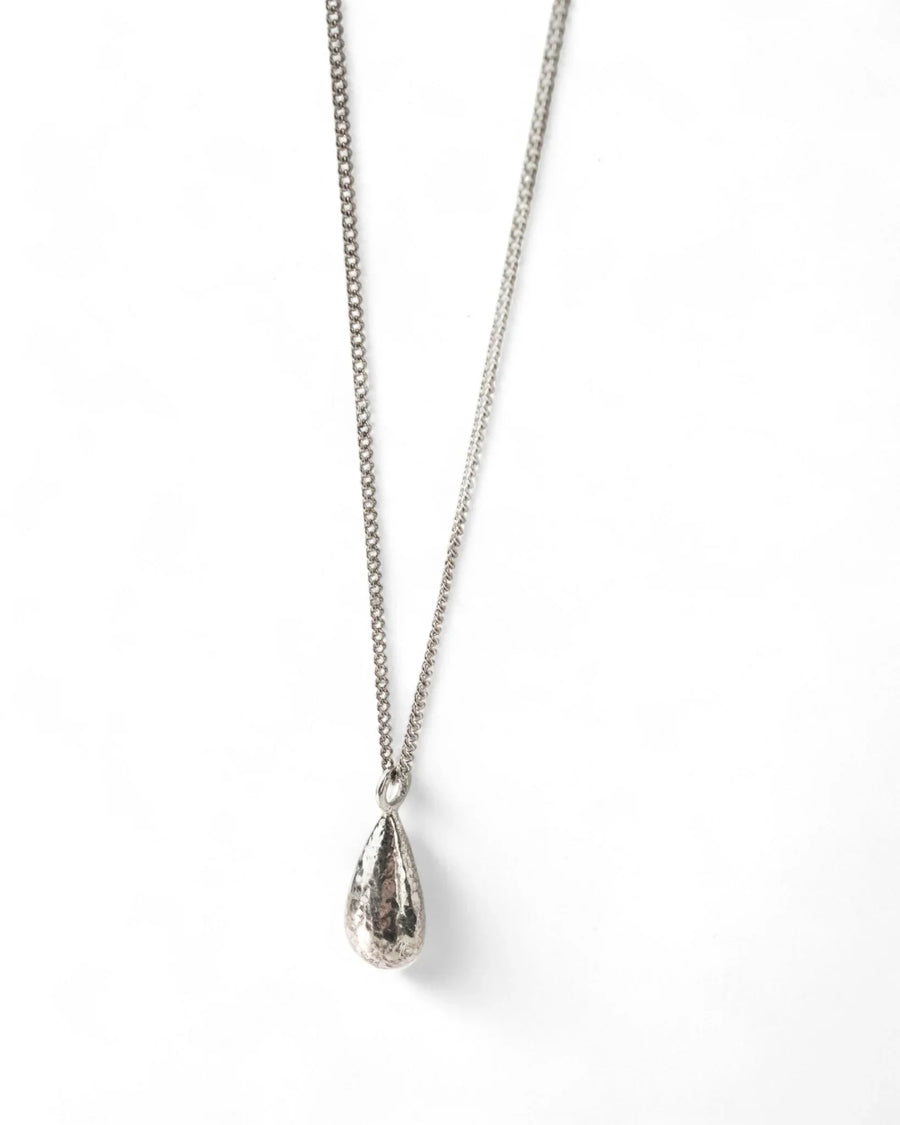Handmade silver teardrop pendant with hammered texture on a delicate chain