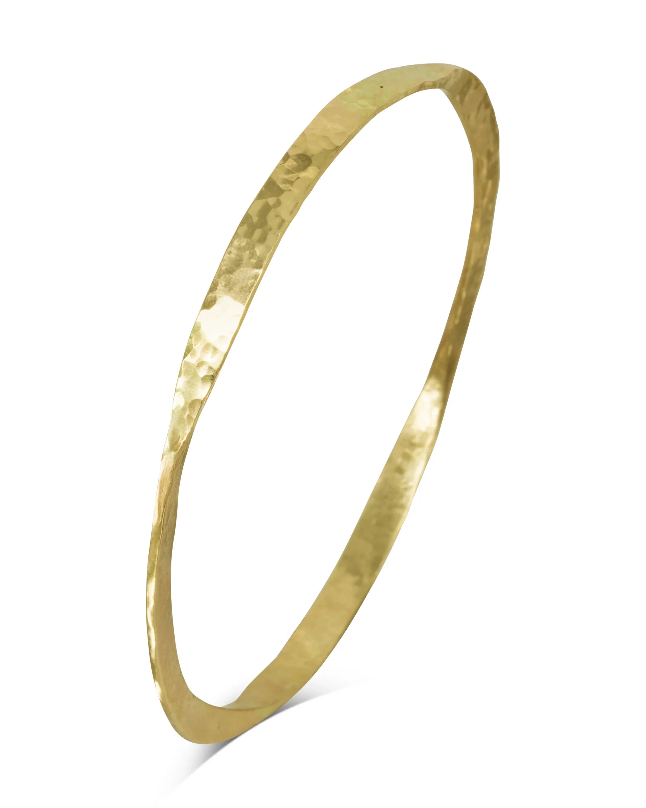 Handmade twisted gold bangle with hammered texture on white background