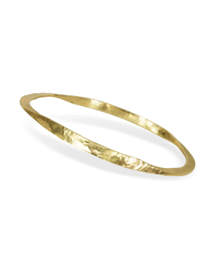 Handmade twisted gold bangle with hammered texture on white background