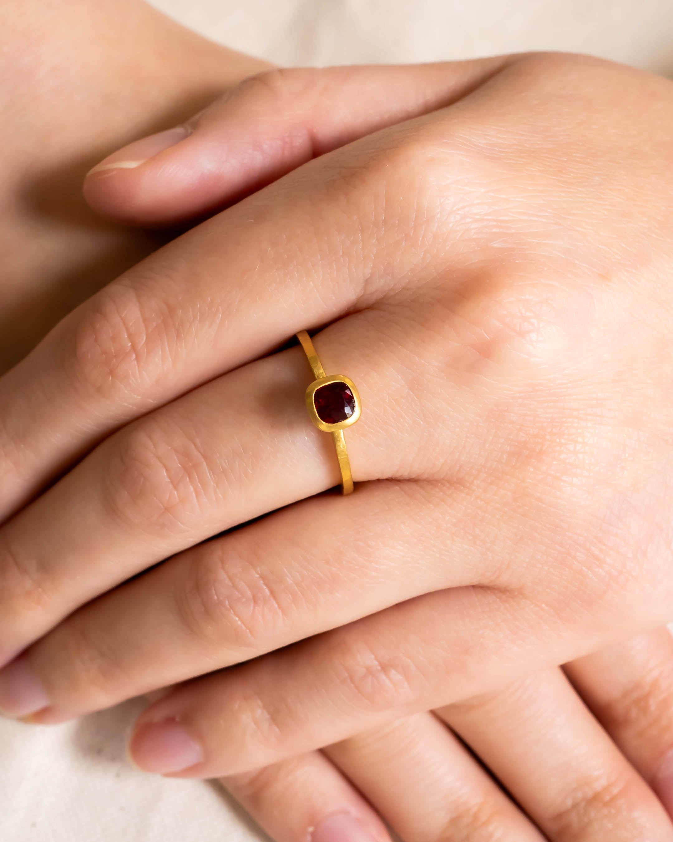 Hammered yellow gold ring with a cushion-cut ruby.