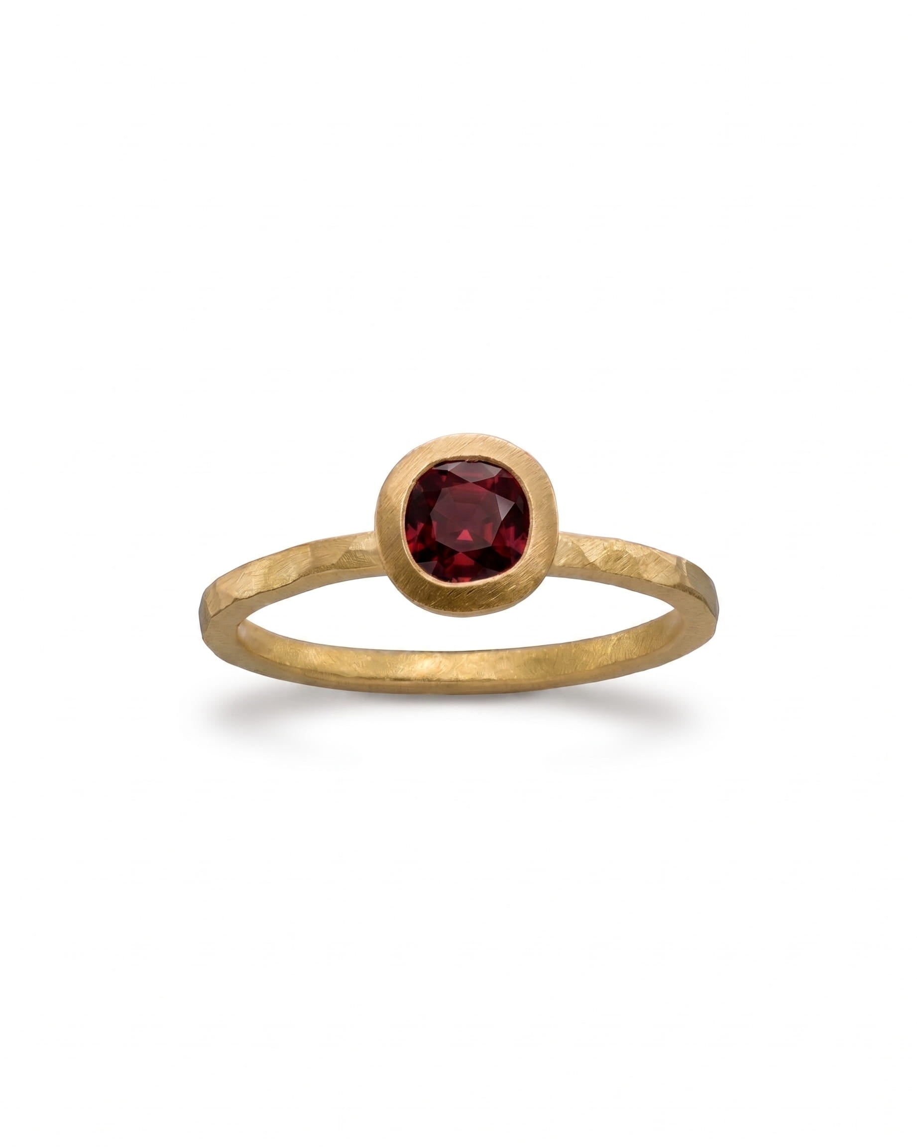 Hammered 9ct yellow gold ring with a round ruby gemstone.