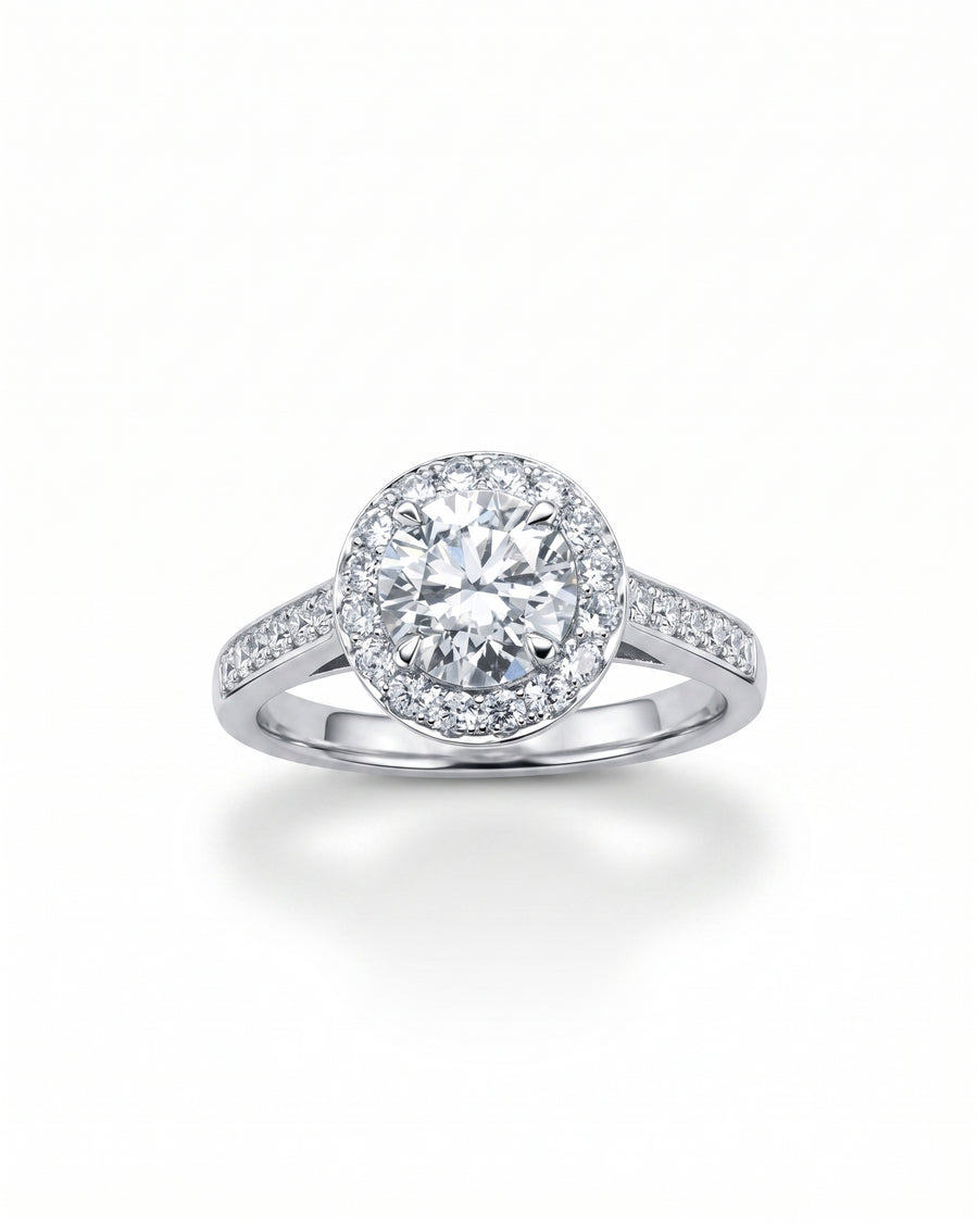 White gold engagement ring with a round diamond cluster and set diamonds.